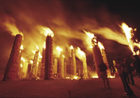 Giant torches burn mystically in the night sky during the Taimatsu Akashi festival